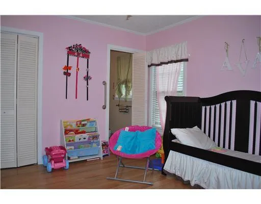 a bedroom with furniture and a chair