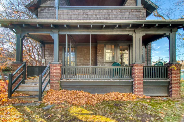 a view of a porch with wooden floor and iron stairs