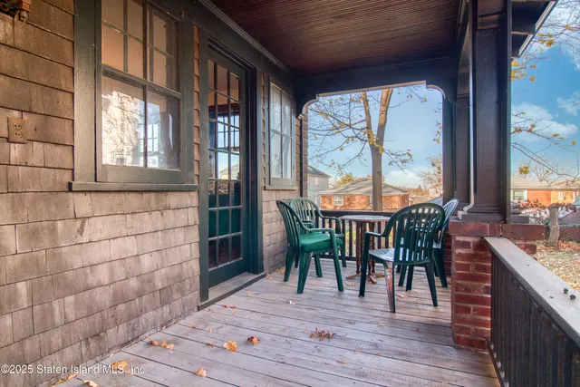 a view of a hallway with wooden floor and windows
