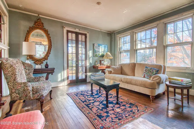 a living room with furniture or couch and a potted plant