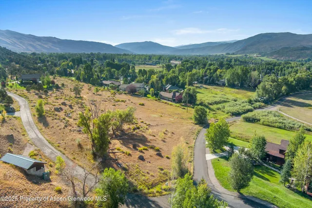 a view of a lush green hillside and a building