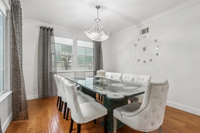 a dining room with furniture and wooden floor