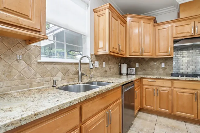 a kitchen with granite countertop stainless steel appliances and cabinets