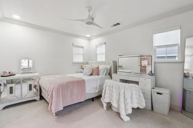 a large bedroom with a bed and a chandelier