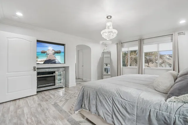 a view of a house with a big yard plants and large trees