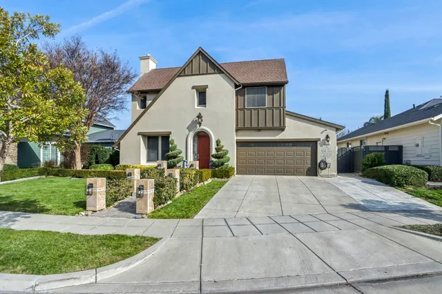 a front view of a house with garden