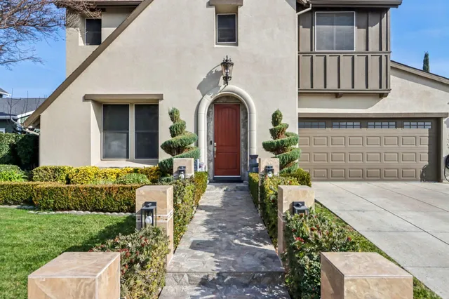 a front view of a house with garden