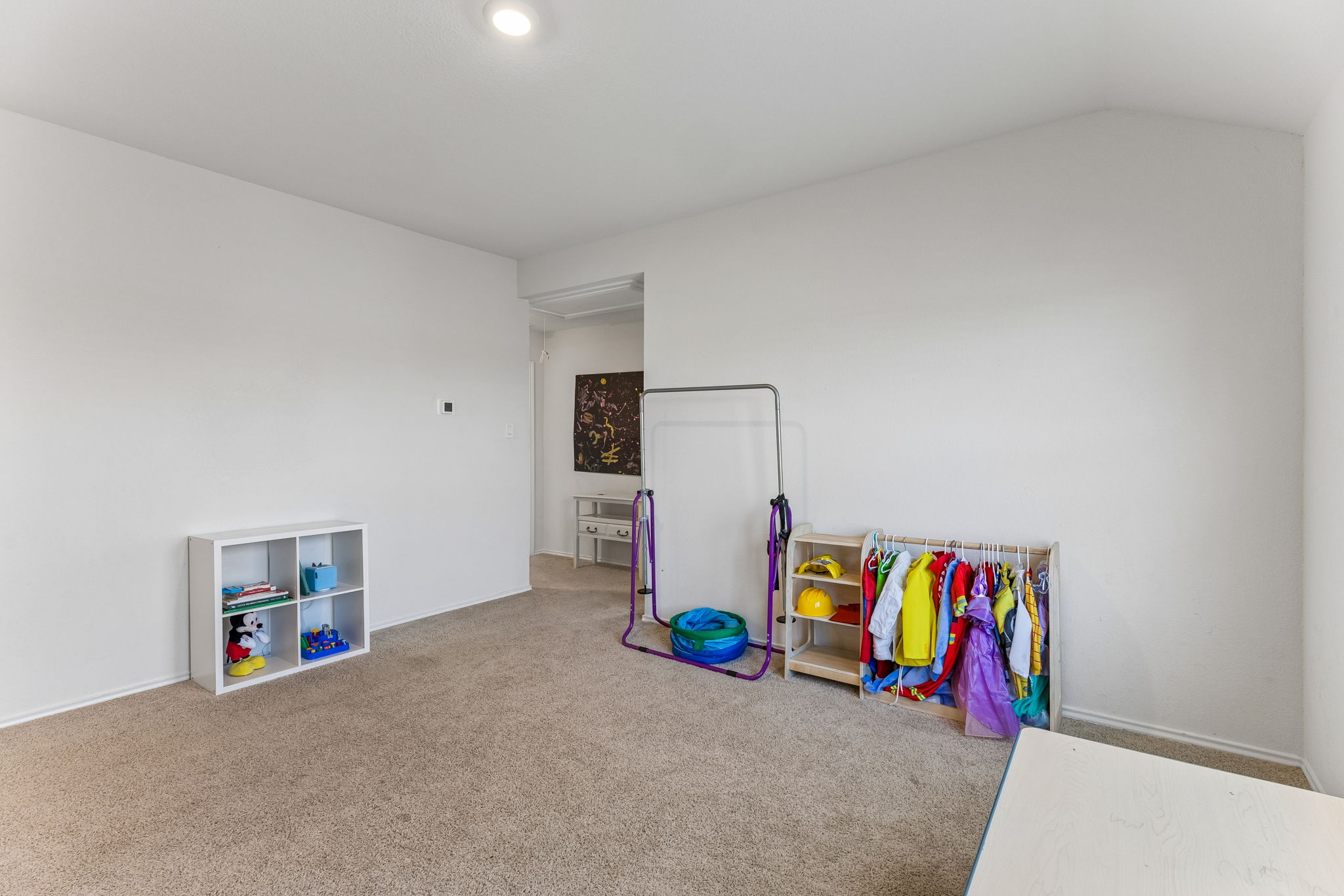 343 Sickle Loop Kyle, TX 78640 - Photo 22 of 40 Carpeted room with a recessed ceiling light, white walls, and a visible doorway
