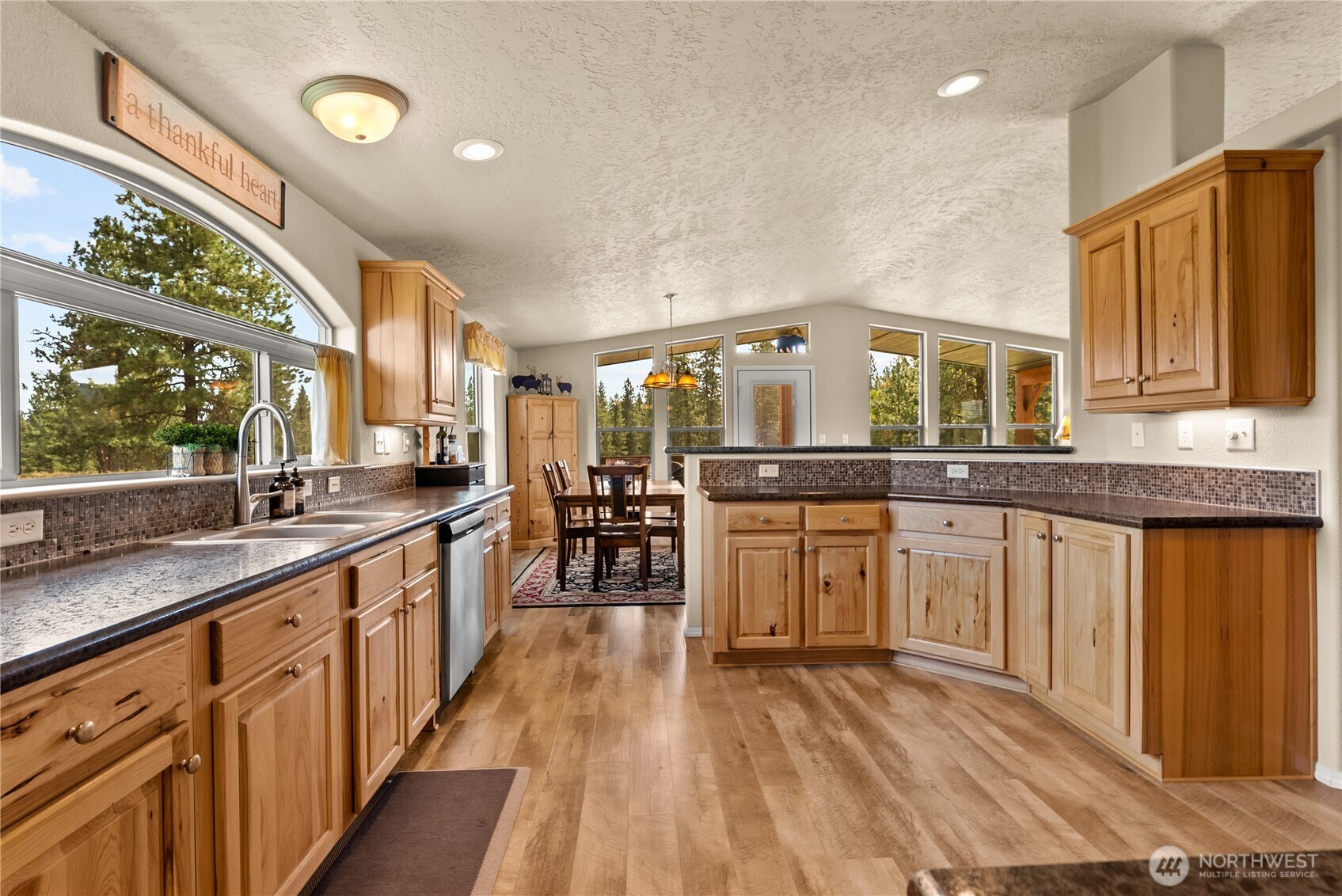 88 Horizon View Winthrop, WA 98862 - Photo 16 of 40 a kitchen with stainless steel appliances granite countertop a stove a sink and a granite counter tops with wooden floors