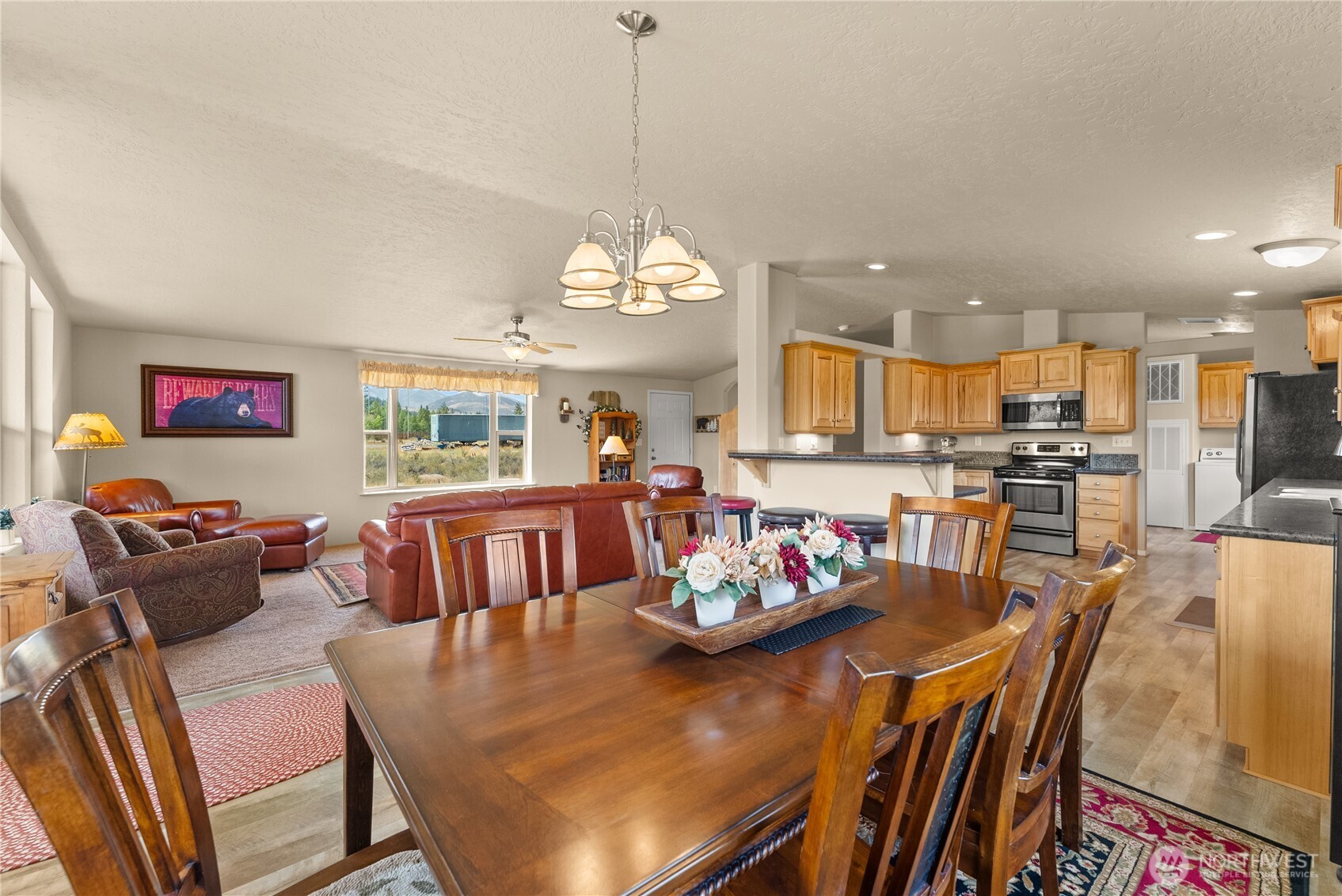 88 Horizon View Winthrop, WA 98862 - Photo 22 of 40 a view of a dining room and livingroom with furniture wooden floor kitchen view and a chandelier