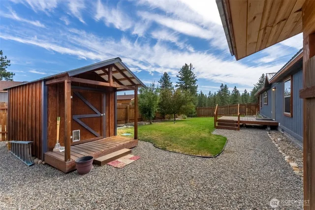 a view of a backyard with wooden fence