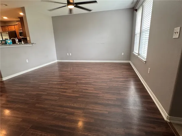 a view of room with window and wooden floor