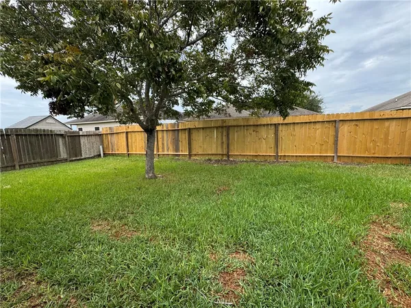 a garden with trees in the background