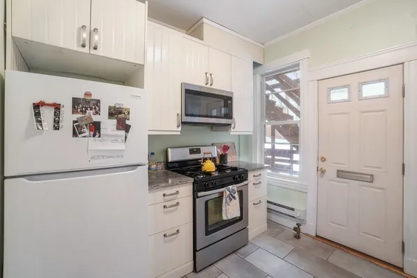 a kitchen with stainless steel appliances granite countertop a refrigerator and a stove