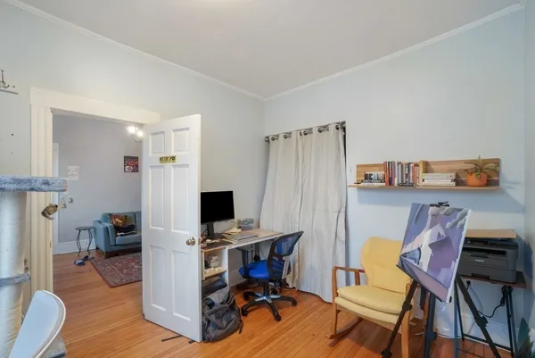 a view of a workspace with furniture and wooden floor
