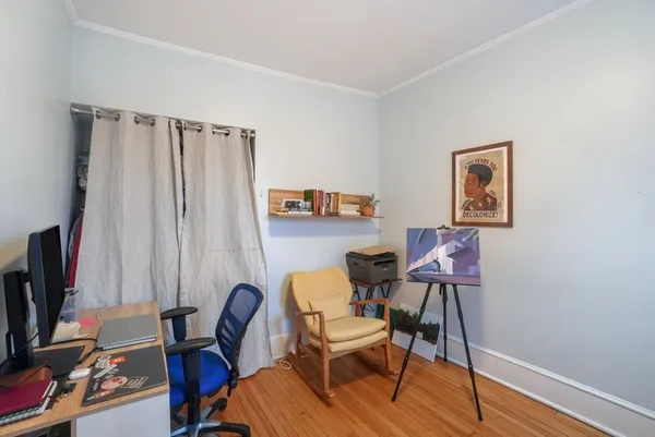 a view of a workspace with furniture and a window