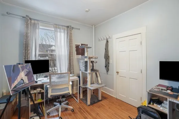 a view of a workspace with furniture and wooden floor