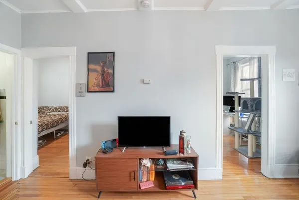 a bedroom with furniture and a flat screen tv