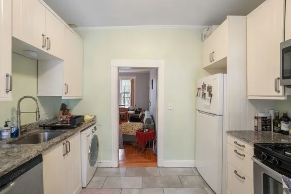 a kitchen with a sink cabinets and appliances