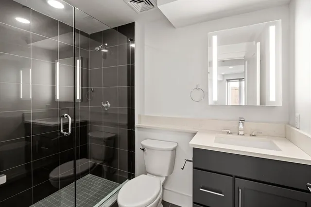 a bathroom with a sink toilet and shower