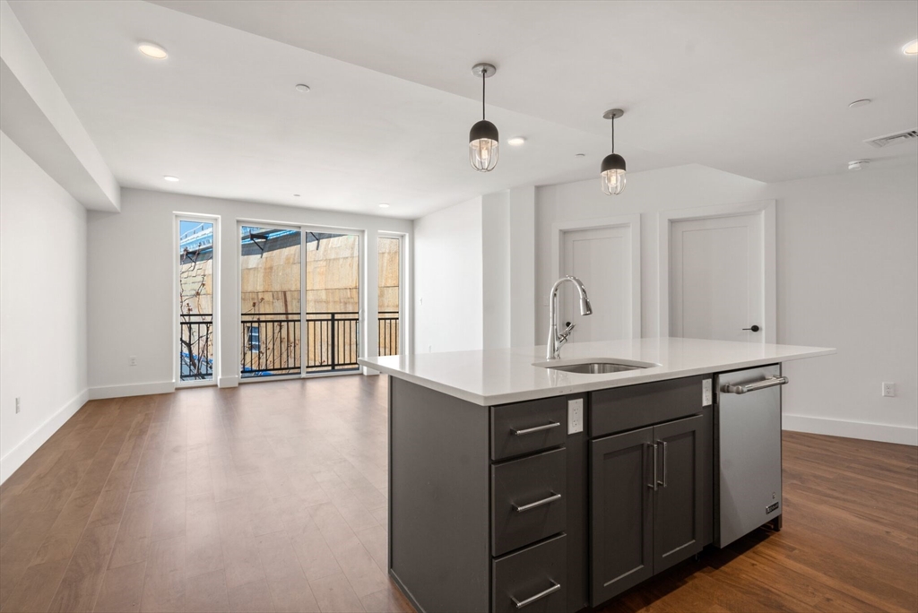 26 Hichborn Street, Unit 5 Boston, MA 02135 - Photo 5 of 17 an empty room with wooden floor and windows