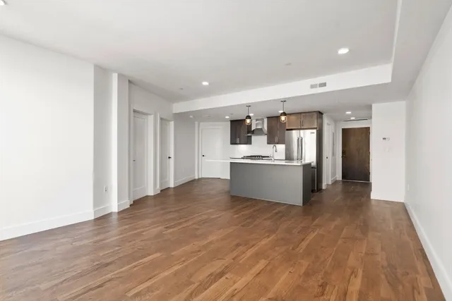 a view of a kitchen with wooden floor and a sink