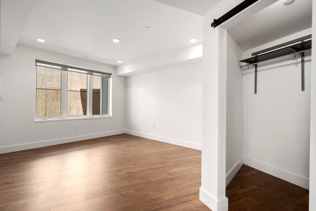 26 Hichborn Street, Unit 5 Boston, MA 02135 - Photo 9 of 17 a view of an empty room with wooden floor and a window