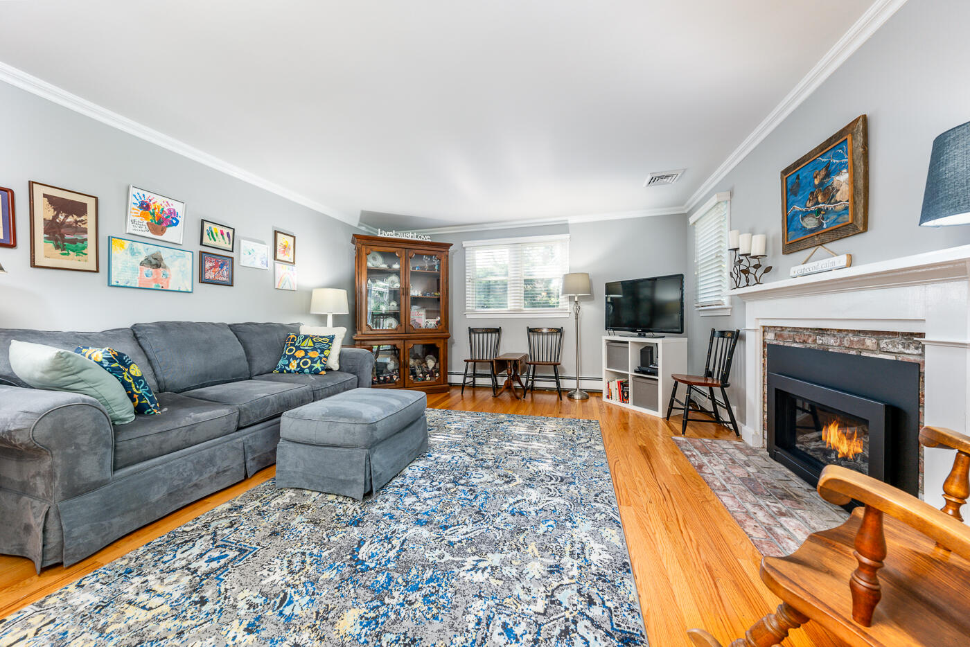 41 Joyce Anne Road Centerville, MA 02632 - Photo 4 of 33 a living room with furniture a flat screen tv and a fireplace