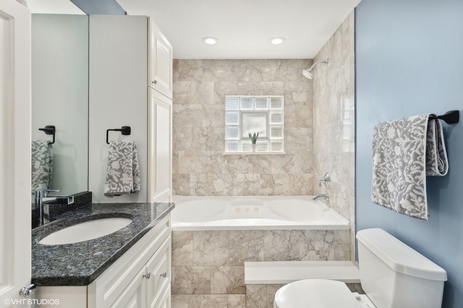 2949 North Rutherford Avenue Chicago, IL 60634 - Photo 5 of 23 a bathroom with a granite countertop tub sink and mirror