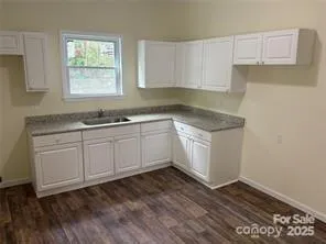 a kitchen with a sink cabinets and window