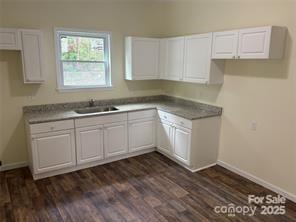 59 Pine Street Great Falls, SC 29055 - Photo 4 of 10 a kitchen with a sink cabinets and window