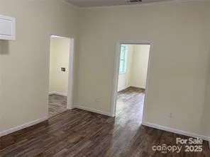 an empty room with wooden floor