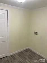 a view of a small space with wooden floor and a window