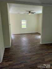 59 Pine Street Great Falls, SC 29055 - Photo 8 of 10 a view of an empty room with wooden floor and a window