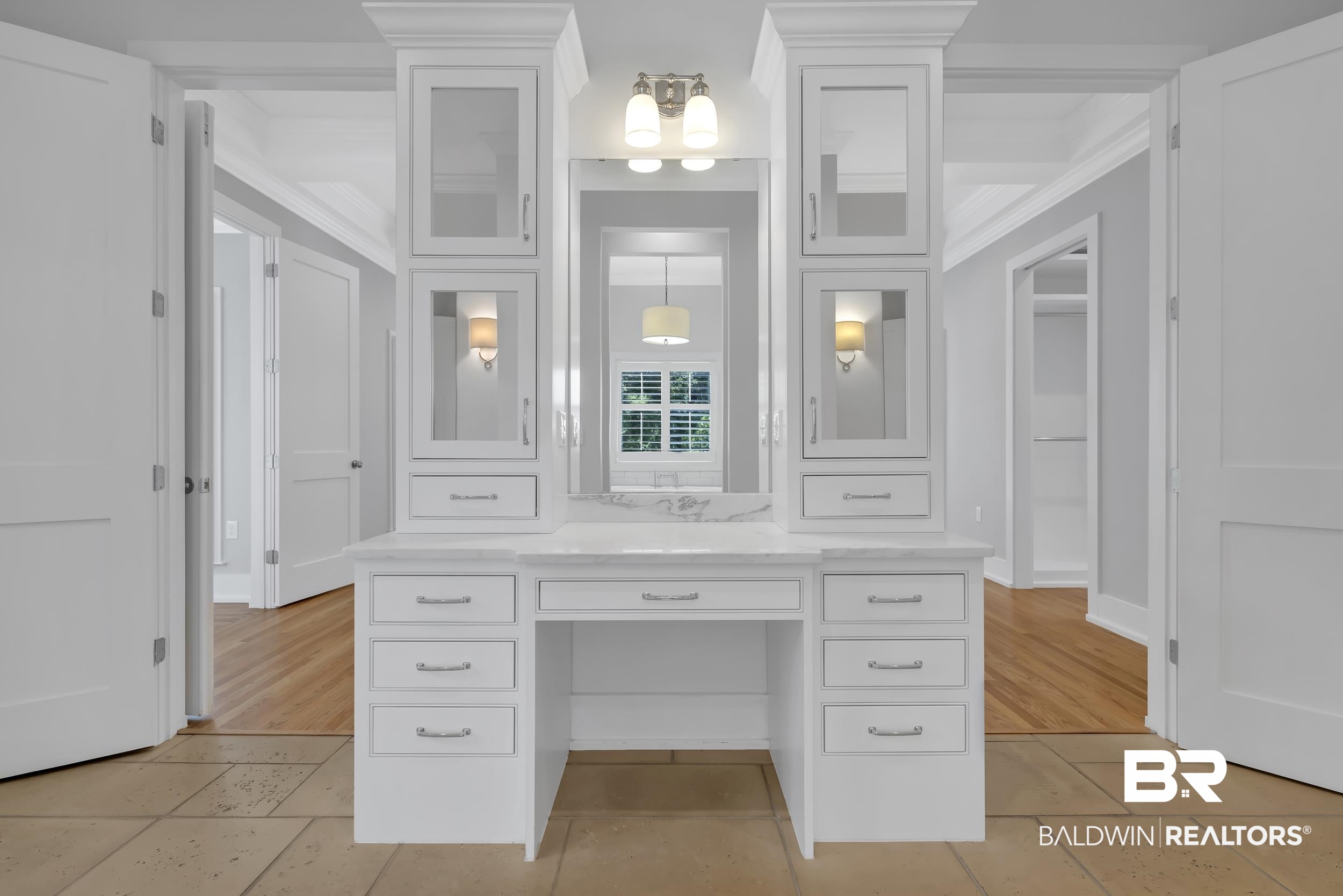 43199 Pine Grove Road Bay Minette, AL 36507 - Photo 50 of 71 Built-in vanity area featuring white cabinetry, glass-front upper cabinets, a light-toned stone countertop, and a tri-light fixture