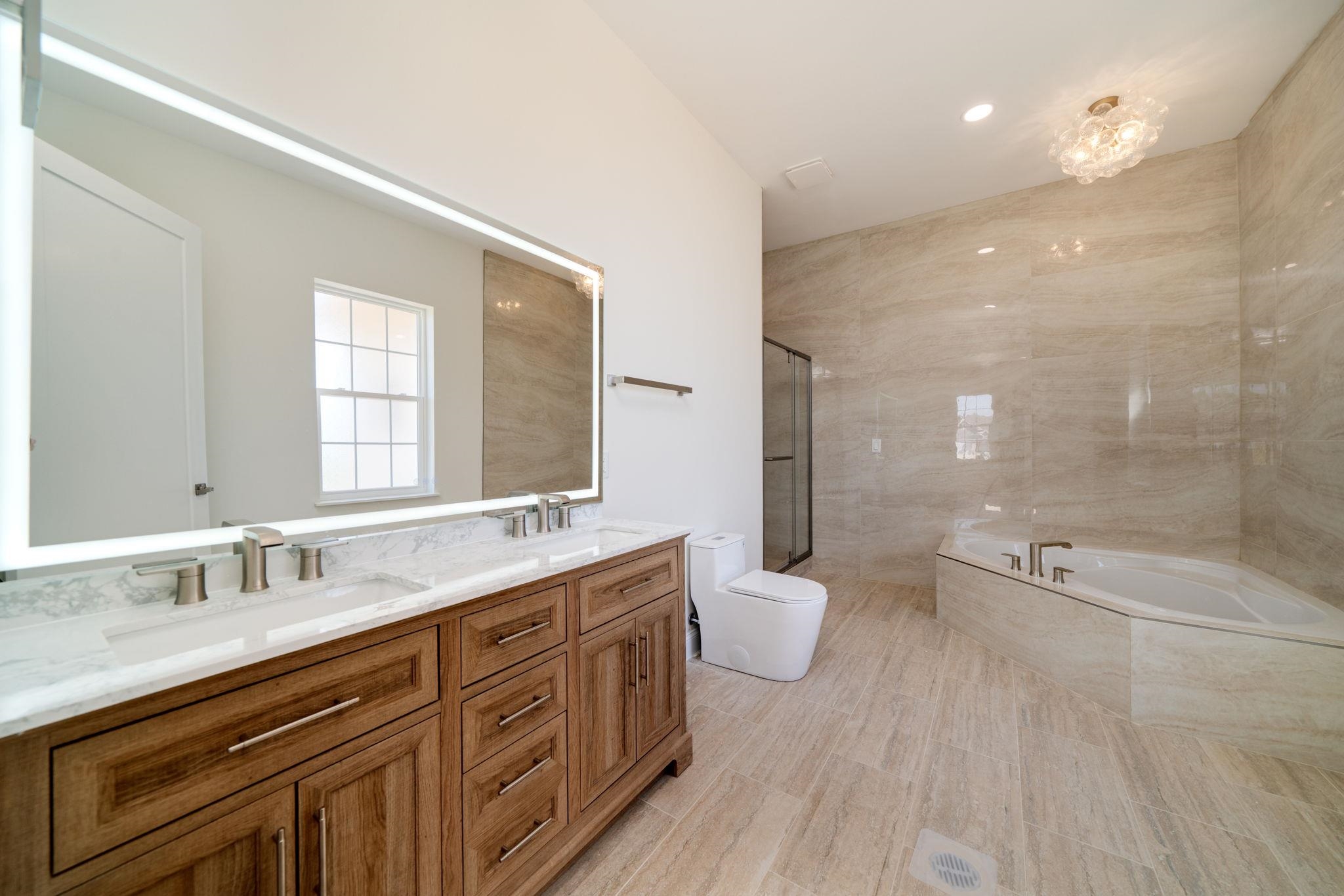 5145 Sycamore Ridge Road Belvidere, IL 61008 - Photo 24 of 57 a bathroom with a granite countertop sink a toilet a mirror and shower