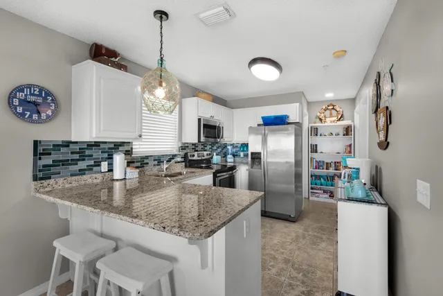 a kitchen with stainless steel appliances a stove sink and microwave