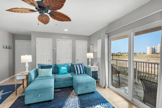 a living room with furniture and a floor to ceiling window