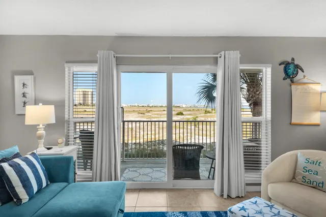 a living room with furniture kitchen view and a flat screen tv