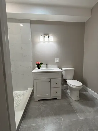 a bathroom with a sink a mirror and a shower