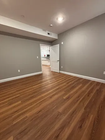 a view of a room with wooden floor and a window