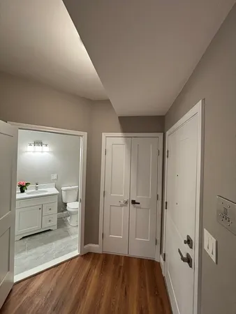 a kitchen with wooden floors and appliances