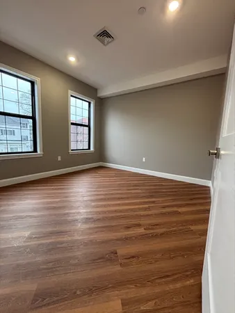 a view of room with window and wooden floor