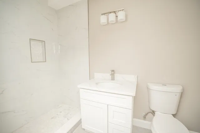 a bathroom with a toilet a sink and a mirror