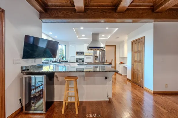 a view of a dining room with furniture wooden floor and chandelier
