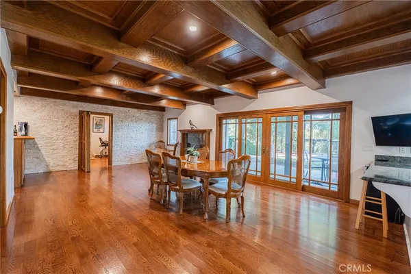 a dining room with furniture and wooden floor