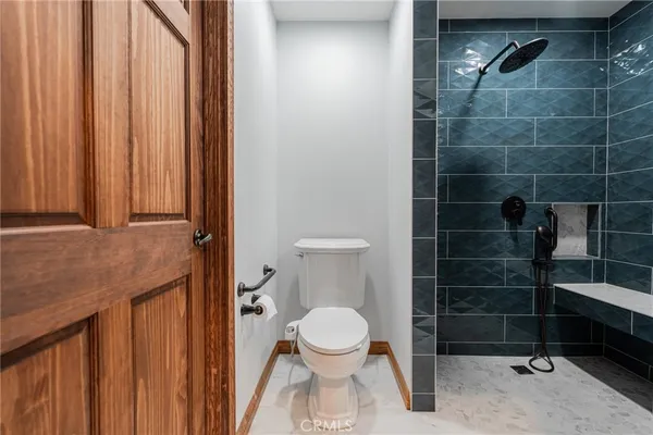 a bathroom with a toilet and a shower