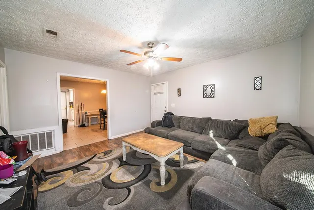 a view of a dining room with furniture and chandelier