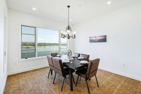 a dining room with furniture a chandelier and wooden floor