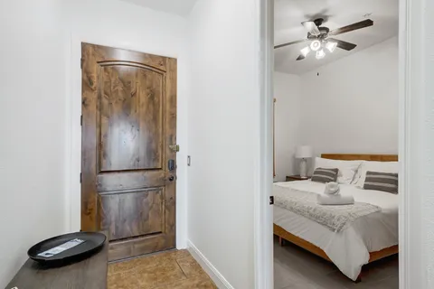 a bedroom with a bed and a chandelier